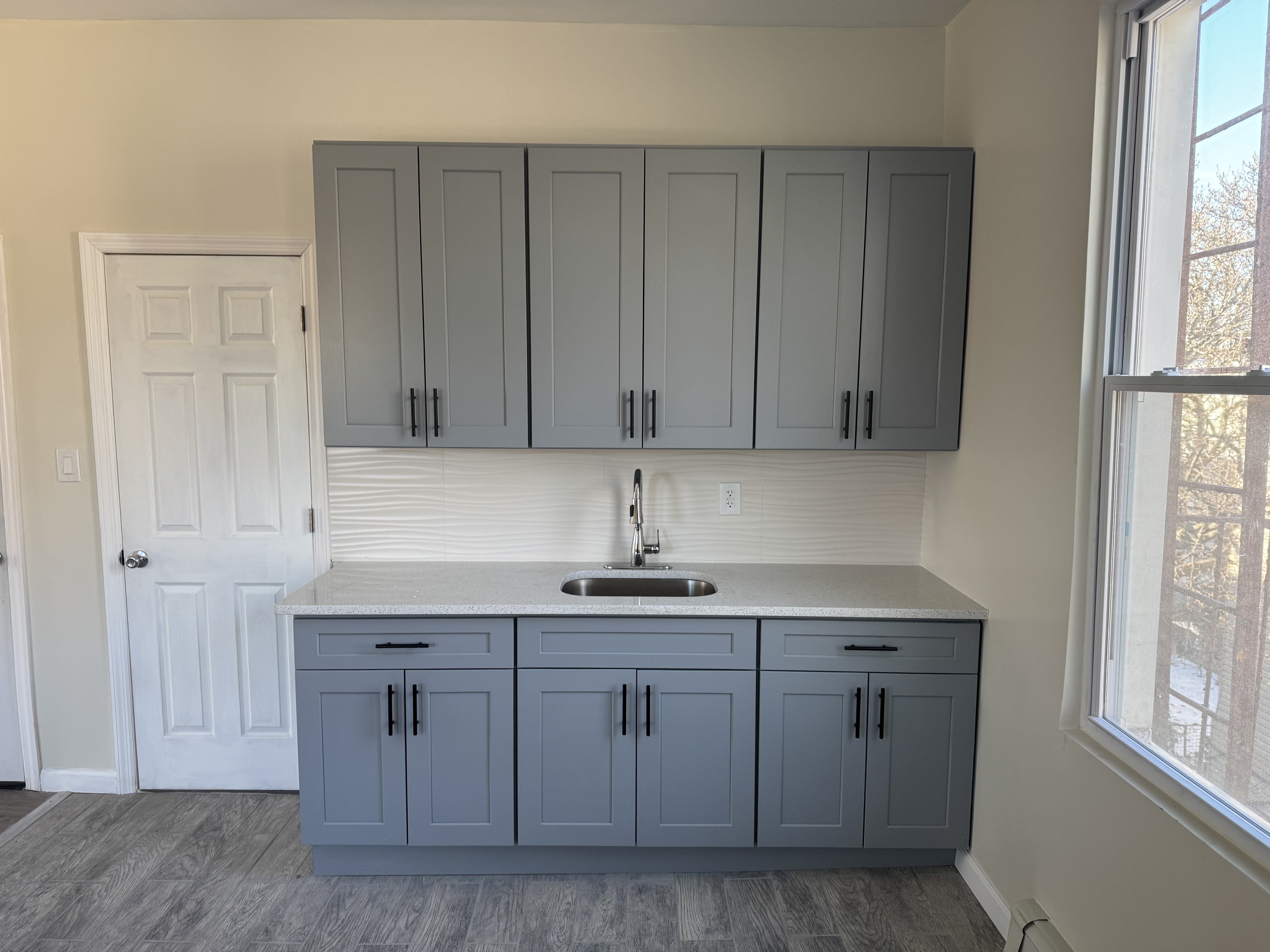 142 Driggs Avenue, Unit 3 Brooklyn, NY 11222 - Photo 4 of 8 a kitchen with white cabinets