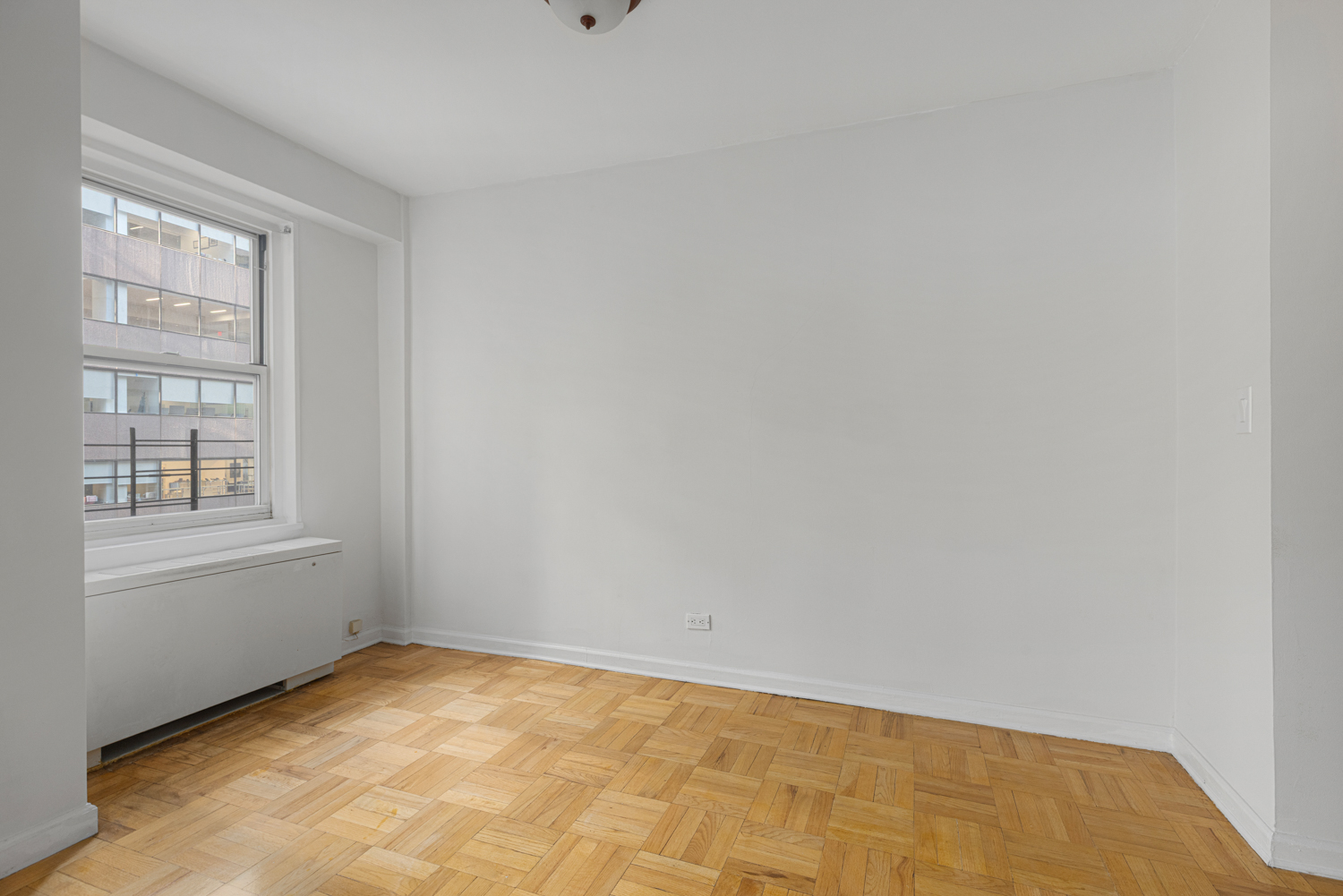 136 East 56th Street, Unit 9J Manhattan, NY 10022 - Photo 9 of 14 a view of empty room with window