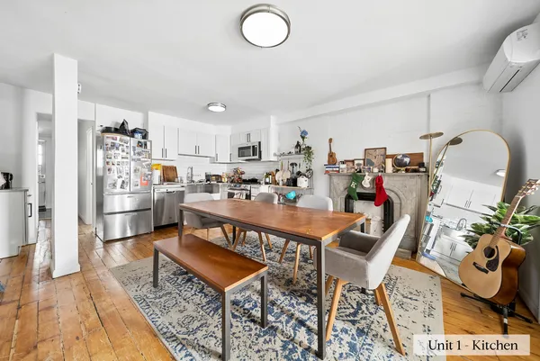 a living room with lots of furniture and kitchen view