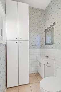 a bathroom with a toilet sink and mirror