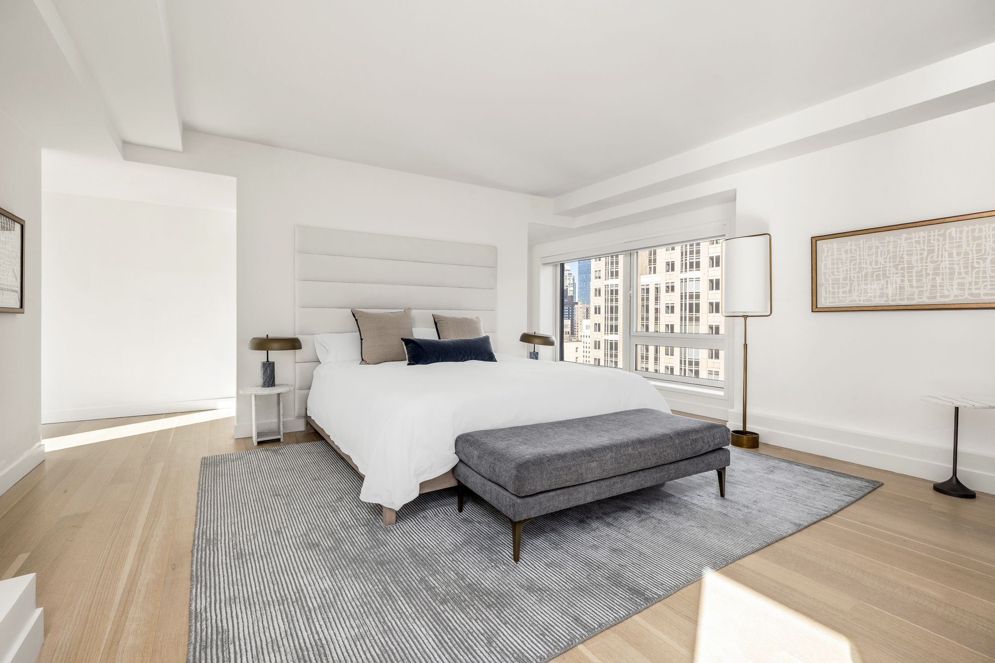 135 West 52nd Street, Unit 40A Manhattan, NY 10019 - Photo 12 of 24 a bedroom with a bed and a window