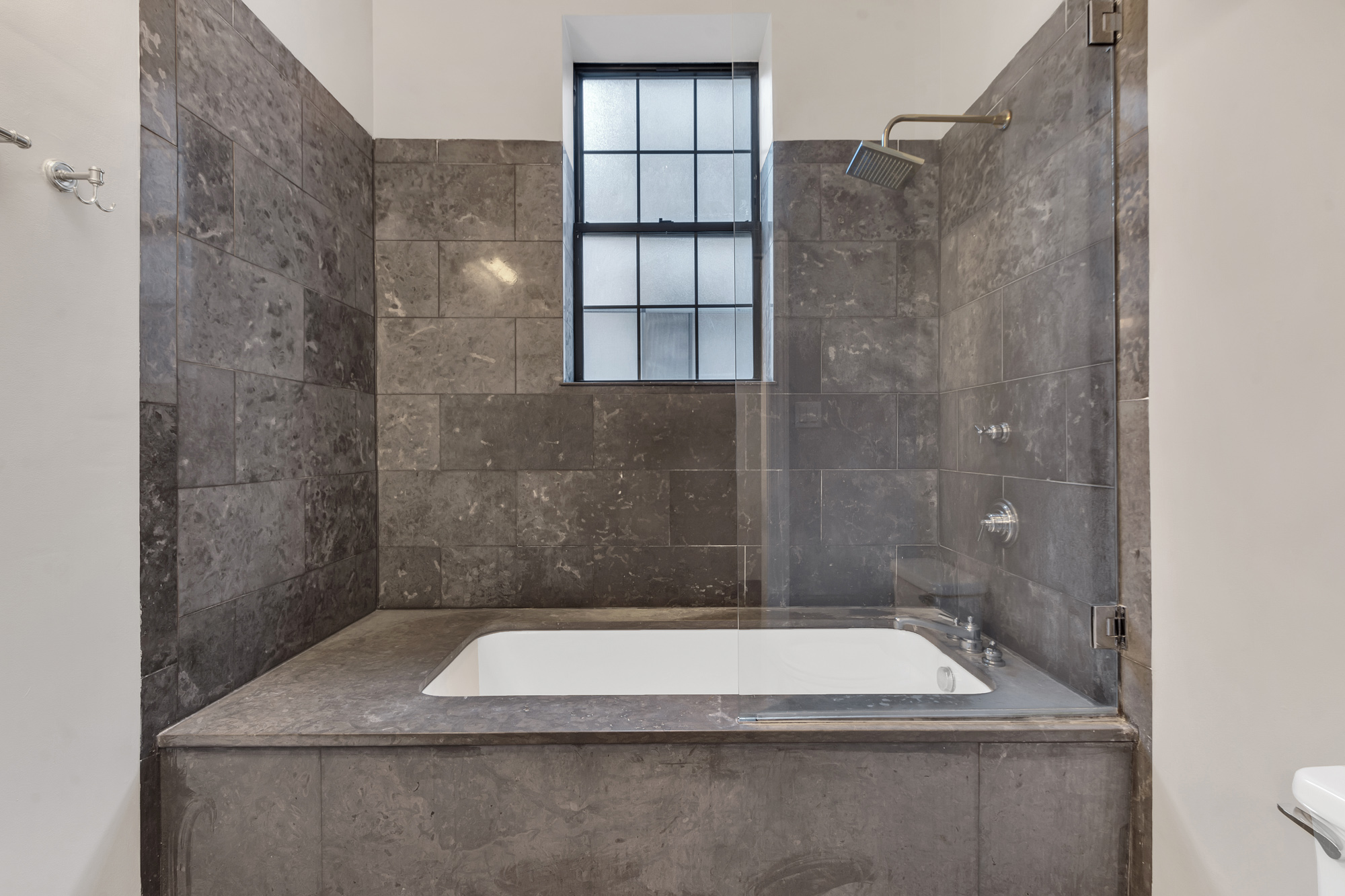 710 St Nicholas Avenue, Unit 2 Manhattan, NY 10031 - Photo 12 of 12 a bathroom with a shower