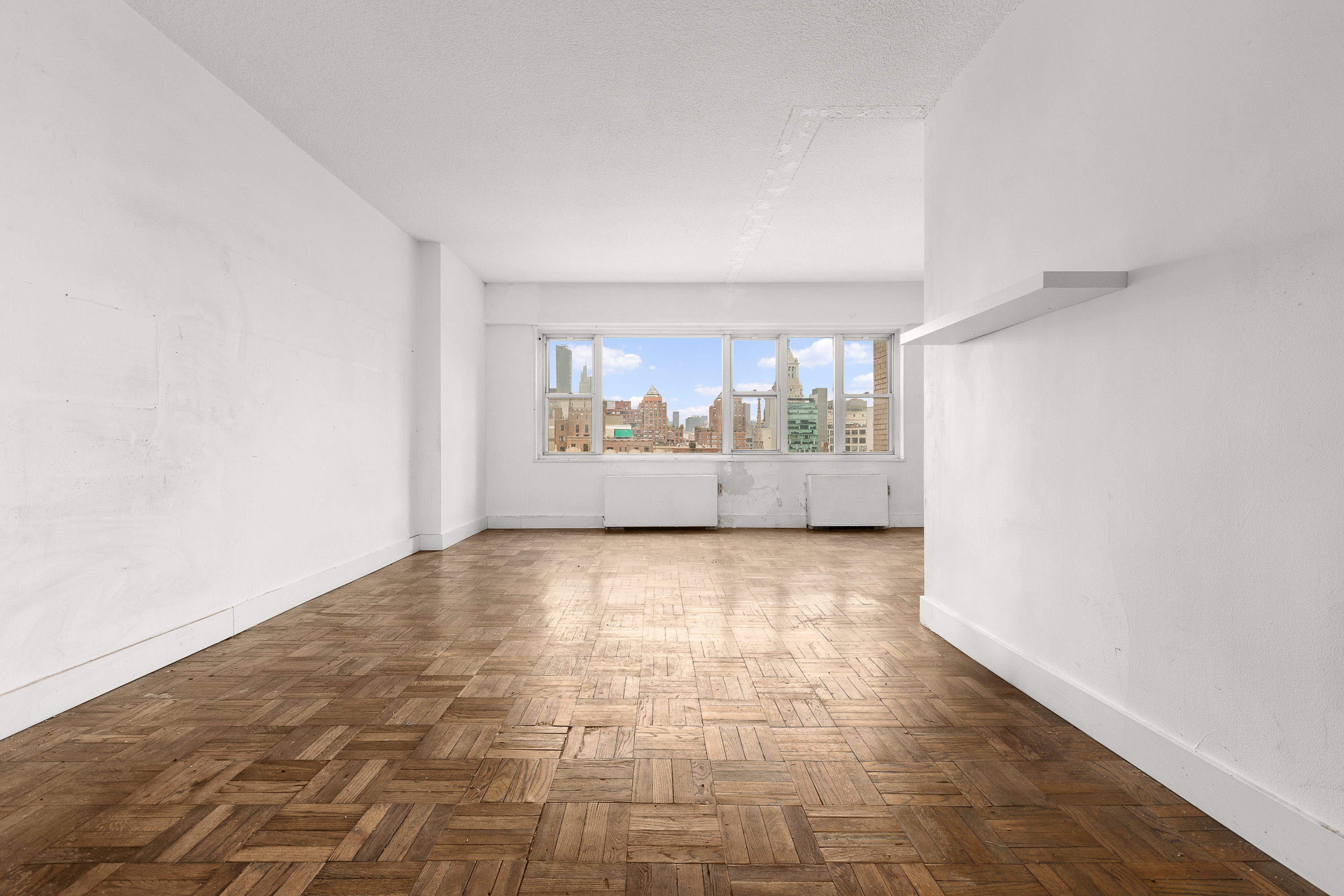 60 East 8th Street, Unit 18J Manhattan, NY 10003 - Photo 2 of 10 a view of an empty room with a window