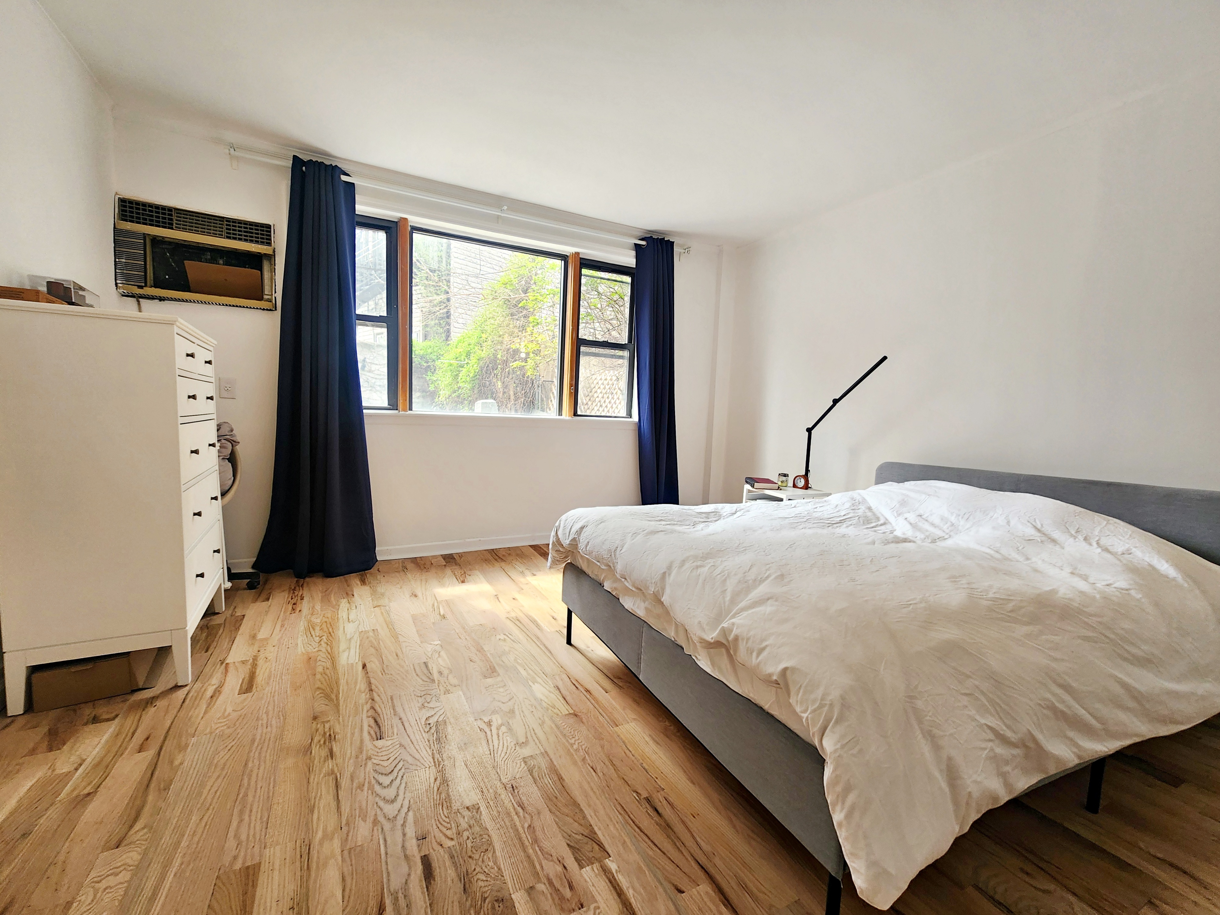 258 Devoe Street, Unit 1 Brooklyn, NY 11211 - Photo 5 of 12 a bedroom with a bed and a large window