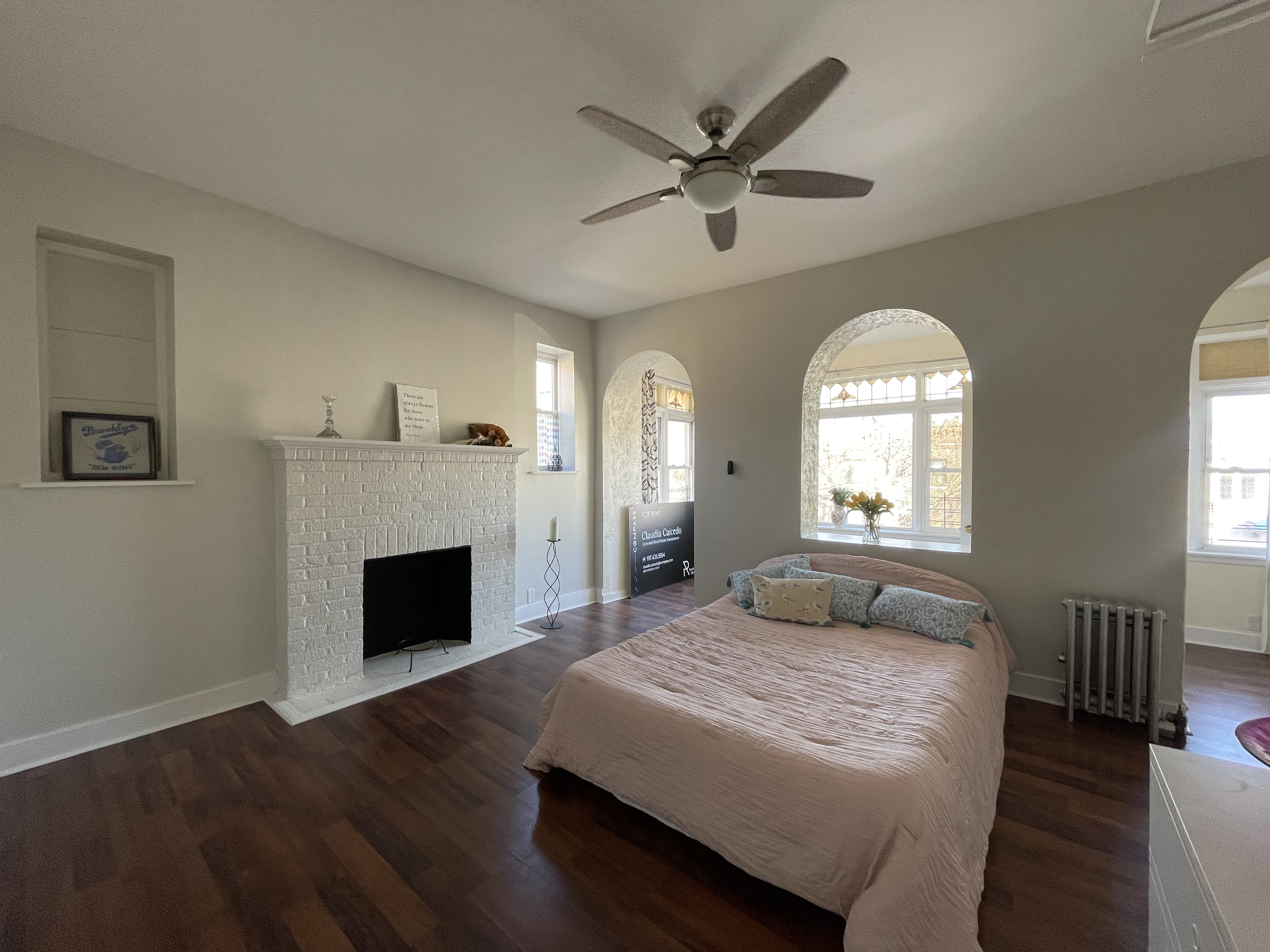 2446 Bedford Avenue, Unit 1 Brooklyn, NY 11226 - Photo 6 of 15 a spacious bedroom with a large bed and a fireplace