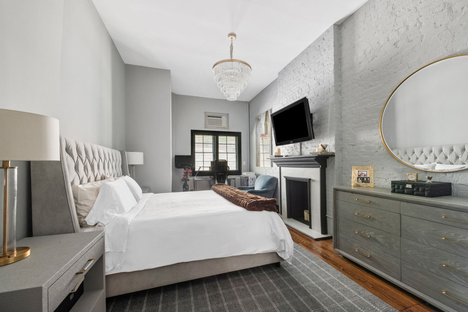 a spacious bedroom with a bed and a flat screen tv