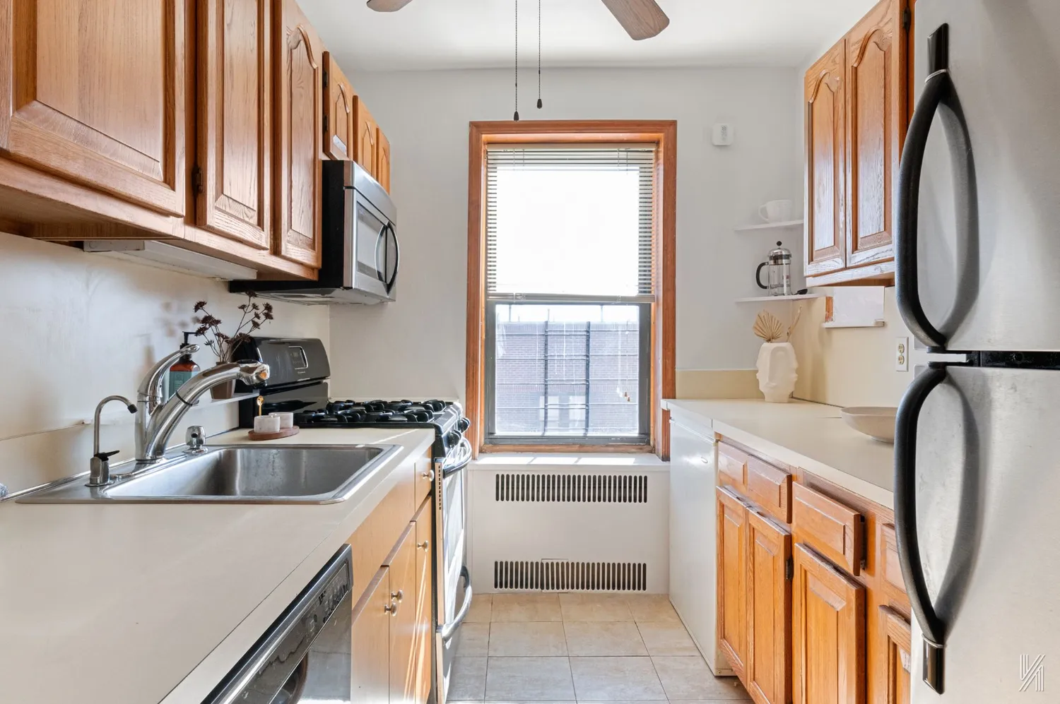 a kitchen with stainless steel appliances granite countertop a sink a stove and a microwave
