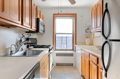 a kitchen with stainless steel appliances granite countertop a sink a stove and a microwave