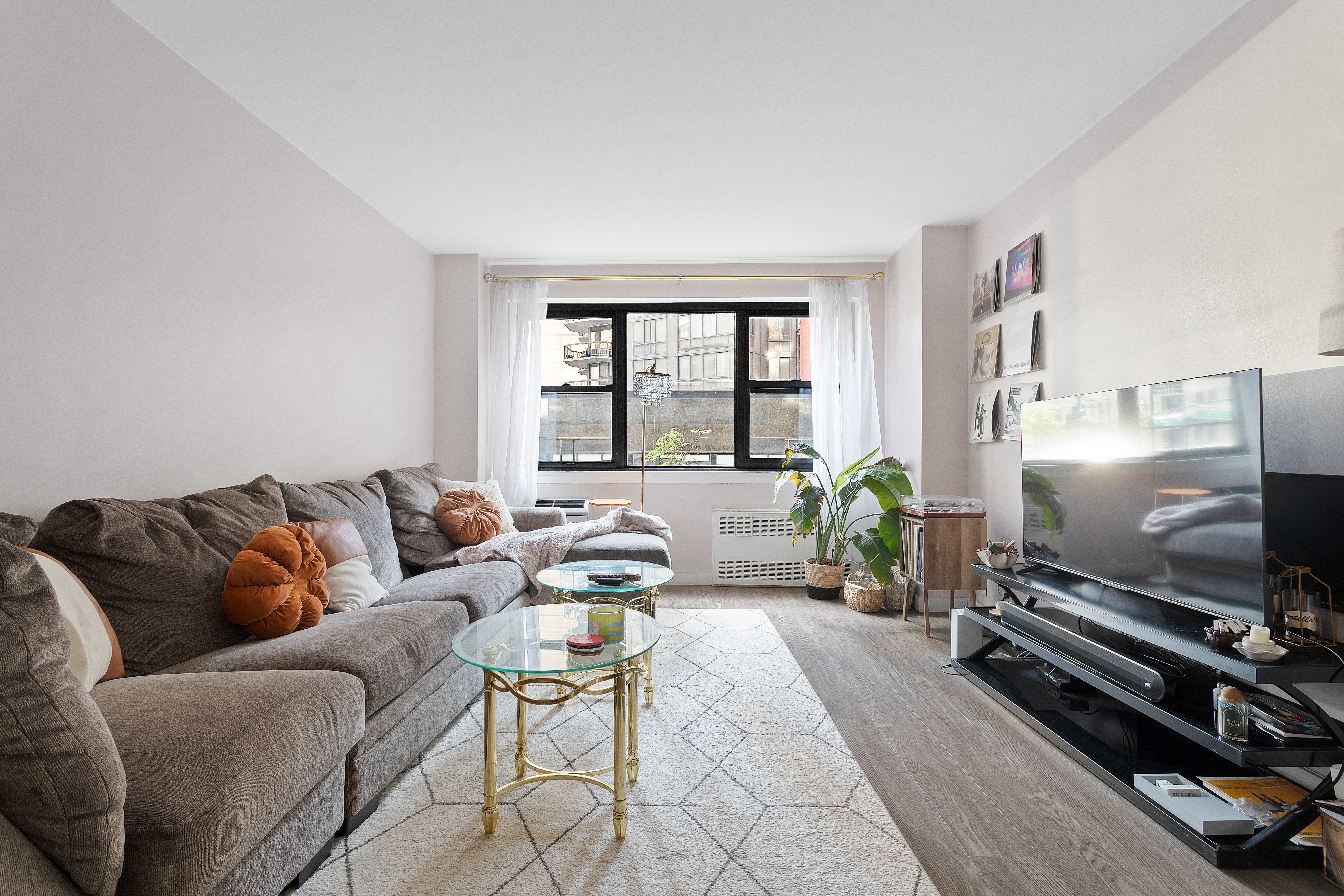 357 East 57th Street, Unit 2E Manhattan, NY 10022 - Photo 2 of 15 a living room with furniture and a flat screen tv