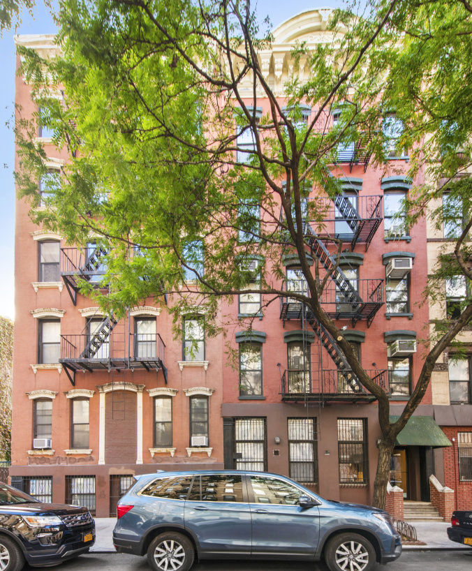 72 East 3rd Street, Unit 5A Manhattan, NY 10003 - Photo 12 of 16 a front view of a building with lot of cars parked