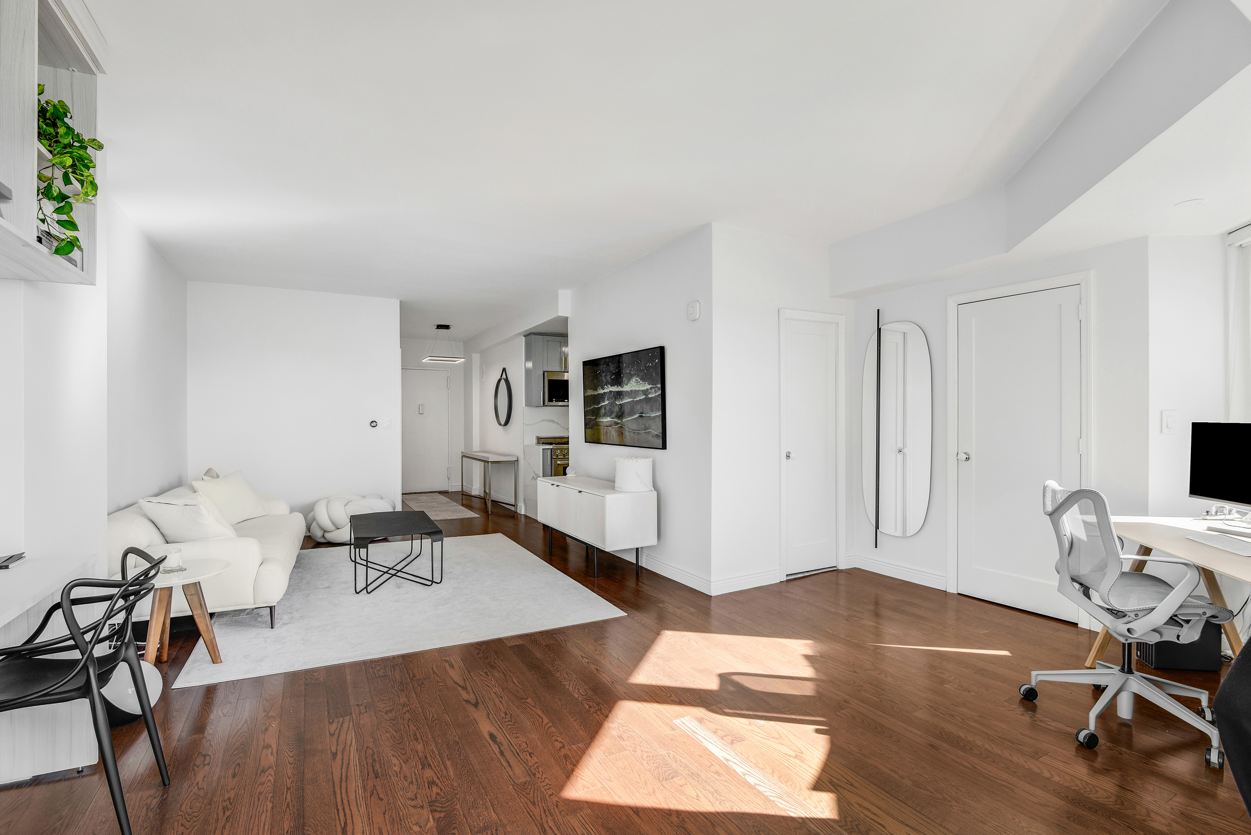 305 East 24th Street, Unit PHL Manhattan, NY 10010 - Photo 2 of 10 a living room with furniture and a wooden floor