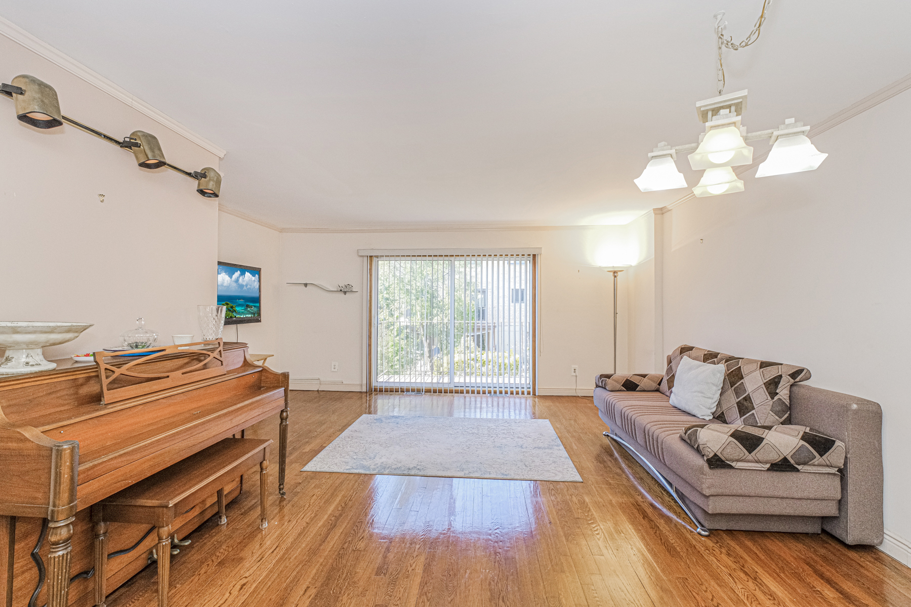 97 Dogwood Lane Staten Island, NY 10305 - Photo 4 of 22 a living room with furniture and a chandelier