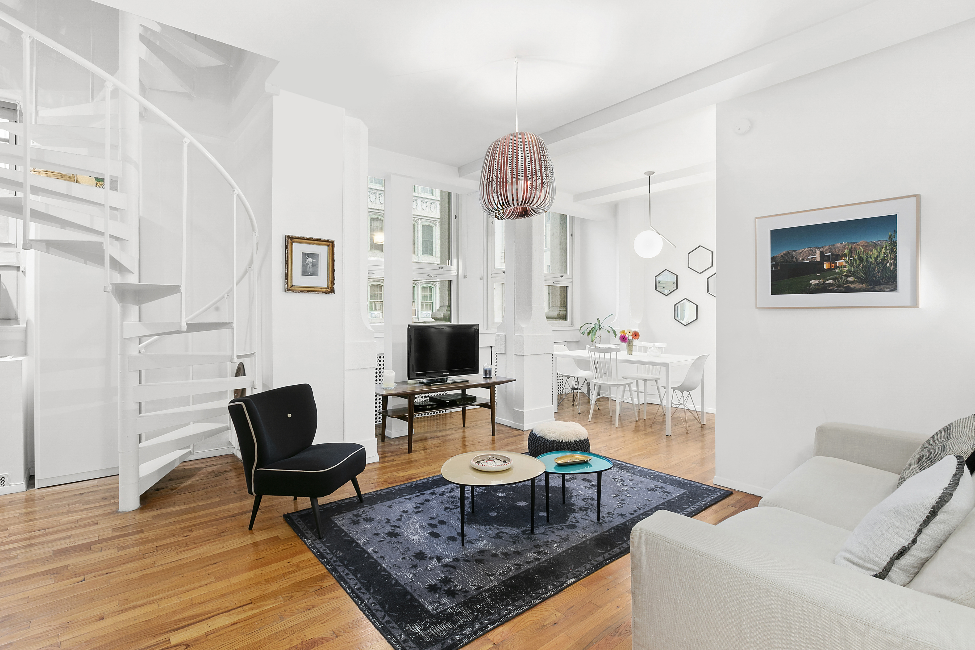 4 Lexington Avenue, Unit 8F Manhattan, NY 10010 - Photo 1 of 7 a living room with furniture and a flat screen tv