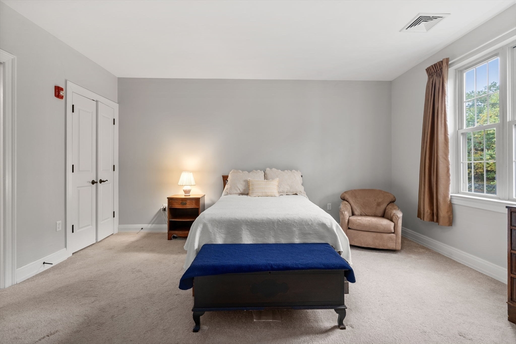 59 Walpole Street, Unit 210 Canton, MA 02021 - Photo 15 of 42 a bedroom with a bed and a couch