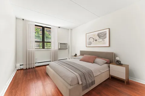 a bedroom with a bed and a window