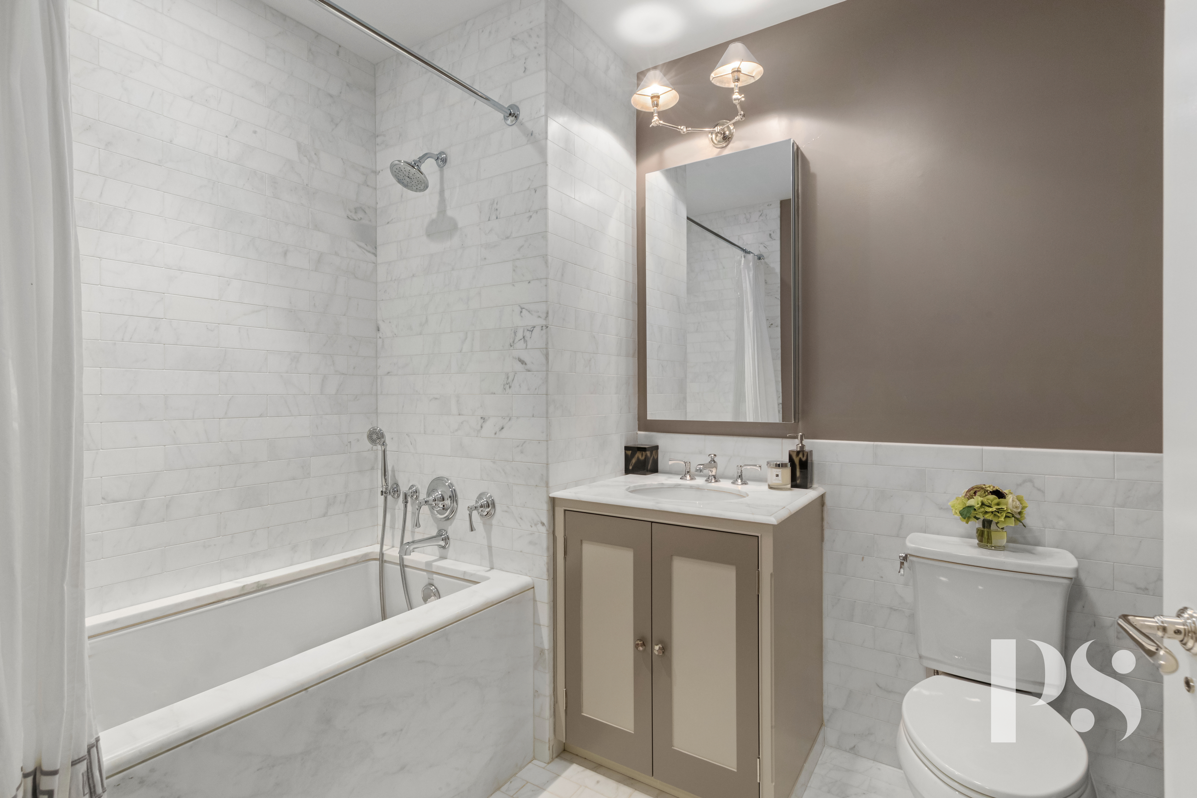 135 East 79th Street, Unit 8E Manhattan, NY 10075 - Photo 21 of 26 a bathroom with a tub sink and mirror