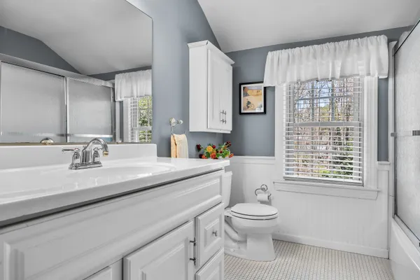 a bathroom with a glass shower door