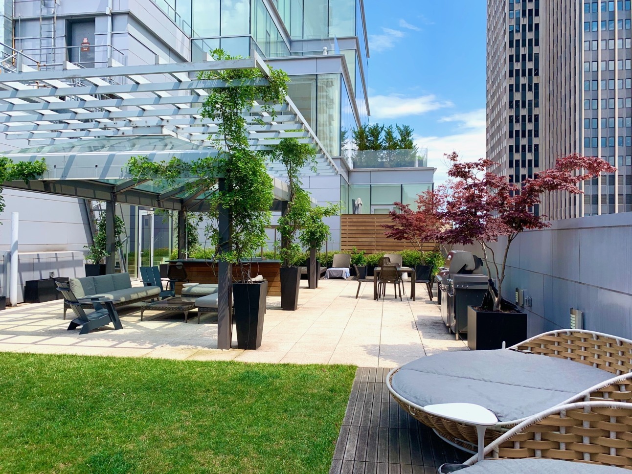 93 Worth Street, Unit PH5 Manhattan, NY 10013 - Photo 17 of 19 a view of a patio with table and chairs potted plants and a palm tree