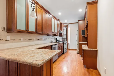 a kitchen with a refrigerator sink and cabinets