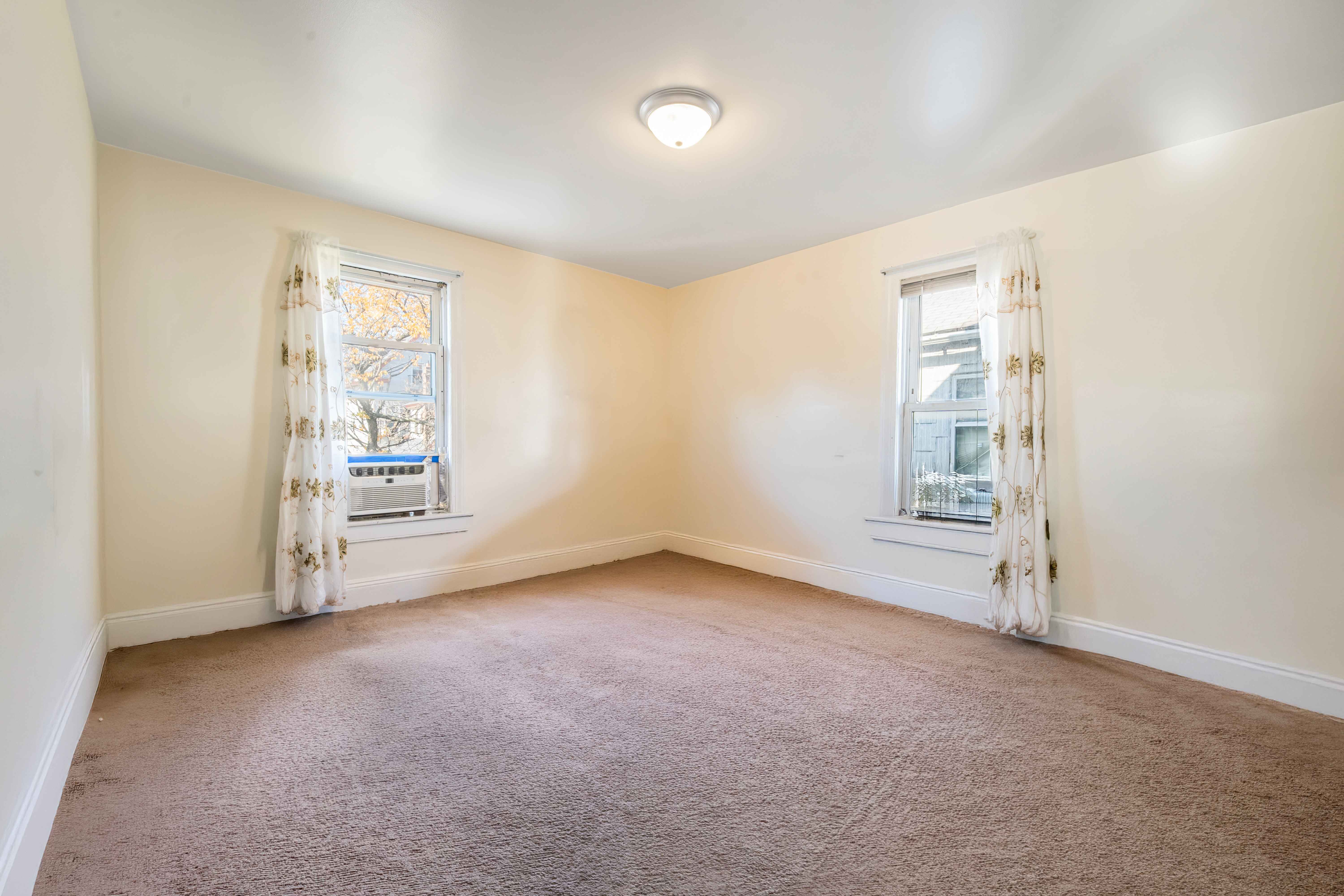 97-30 127th Street Queens, NY 11419 - Photo 3 of 27 an empty room with windows