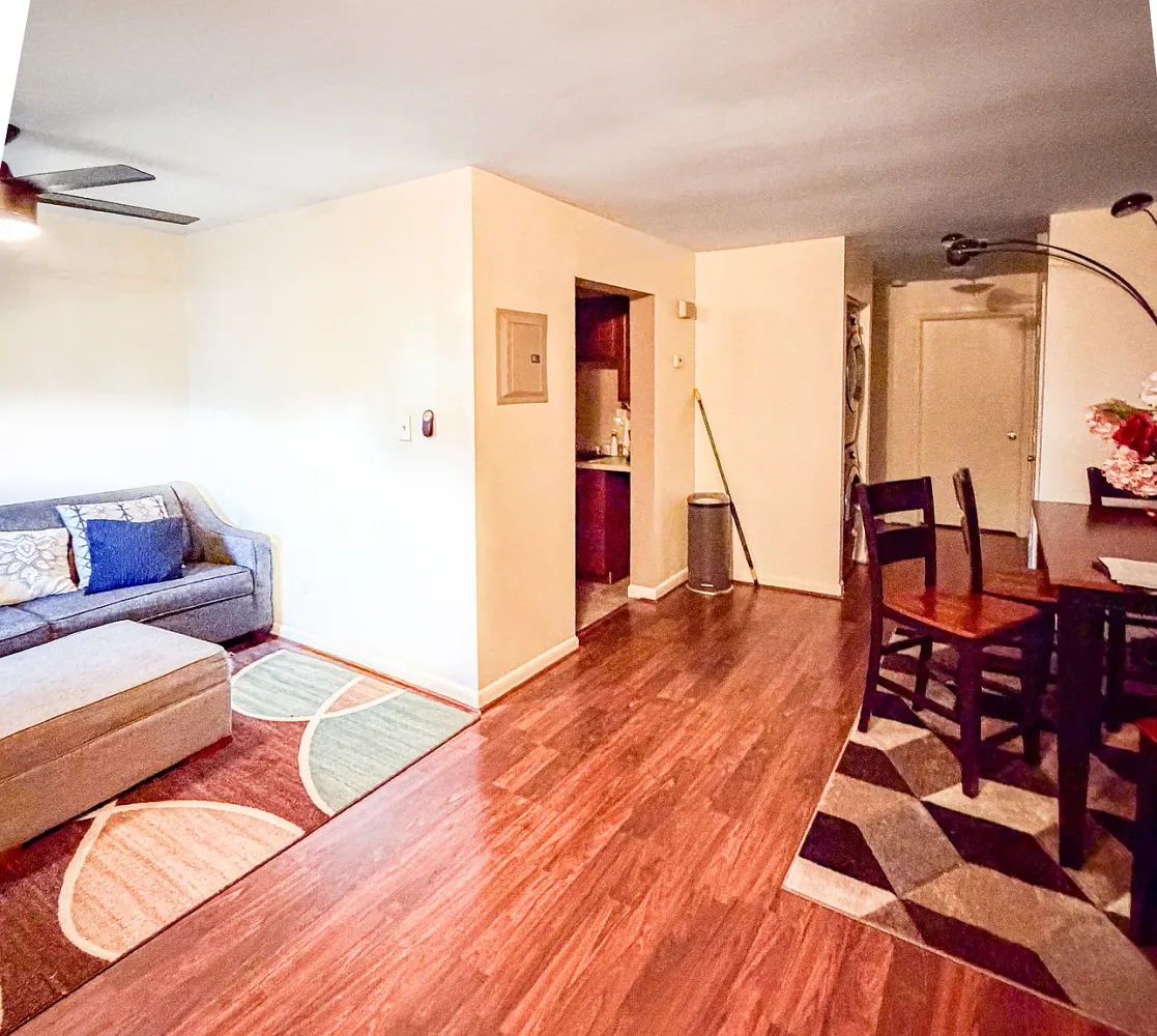 a living room with furniture and wooden floor