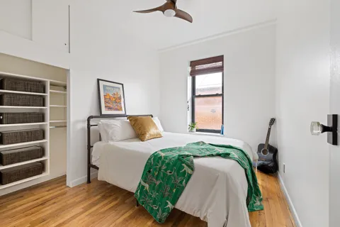 a bedroom with a bed and a window