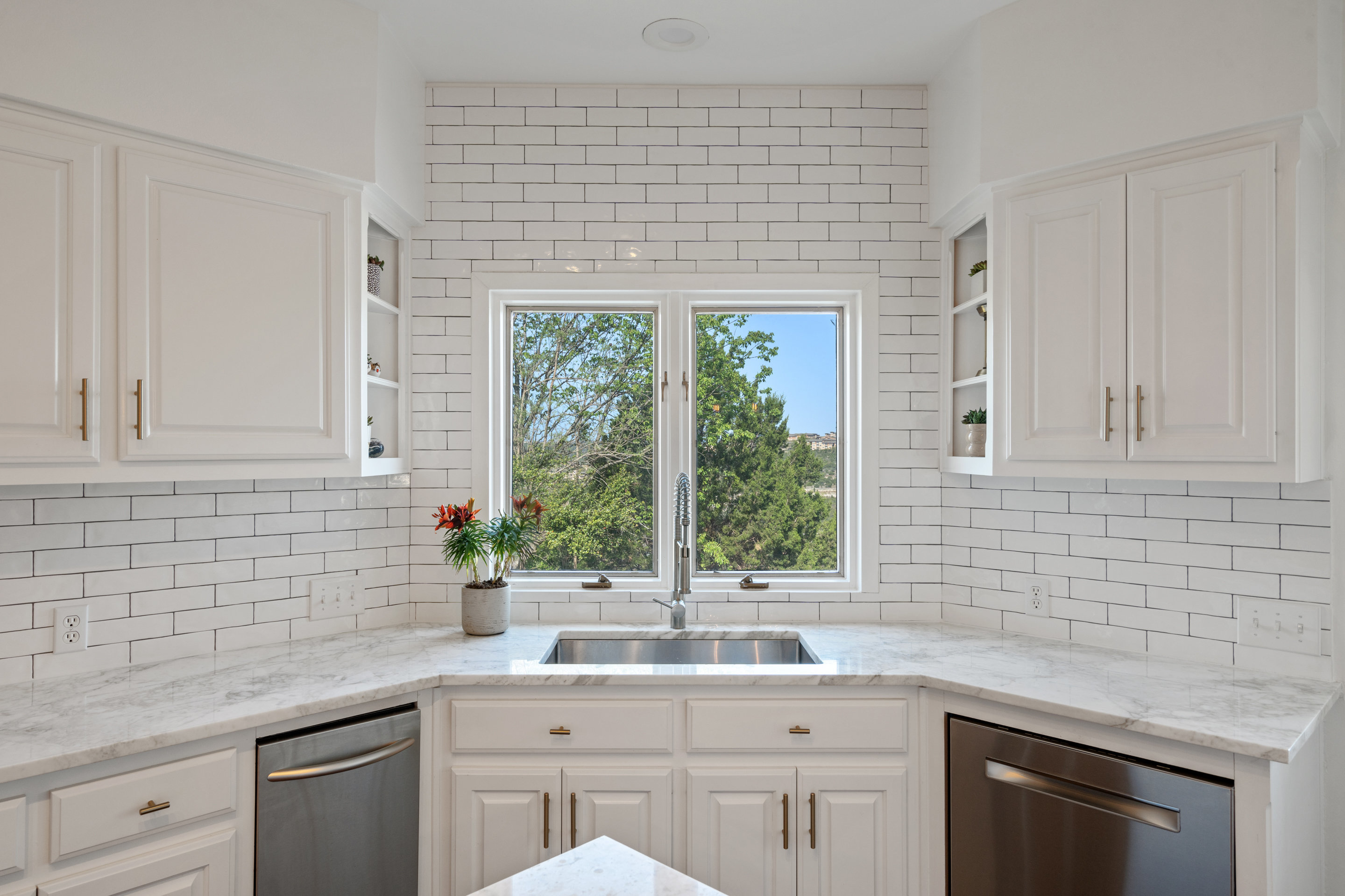 5319 Backtrail Drive Austin, TX 78731 - Photo 16 of 35 a kitchen with a sink cabinets and window