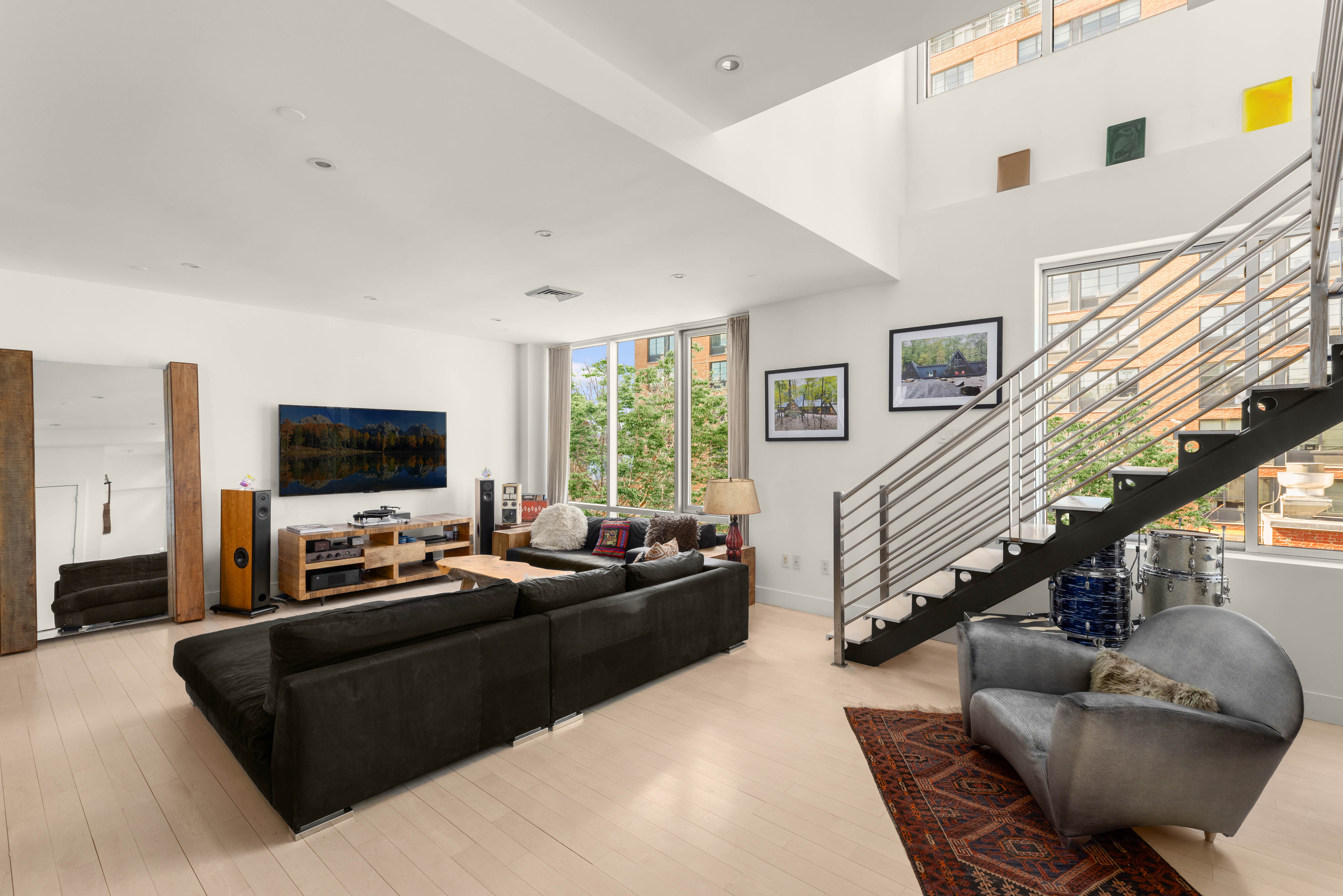 24 Dunham Place, Unit PHA Brooklyn, NY 11249 - Photo 2 of 19 a living room with furniture and a flat screen tv