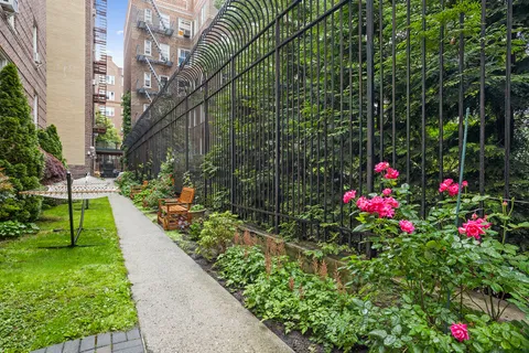 a view of flower garden with a small yard