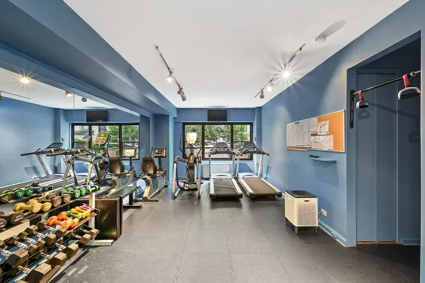 a bedroom with furniture and large windows