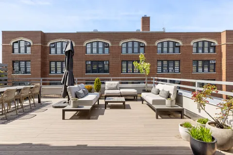 a front view of a building with outdoor seating