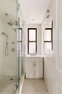 a bathroom with a granite countertop sink a toilet and shower