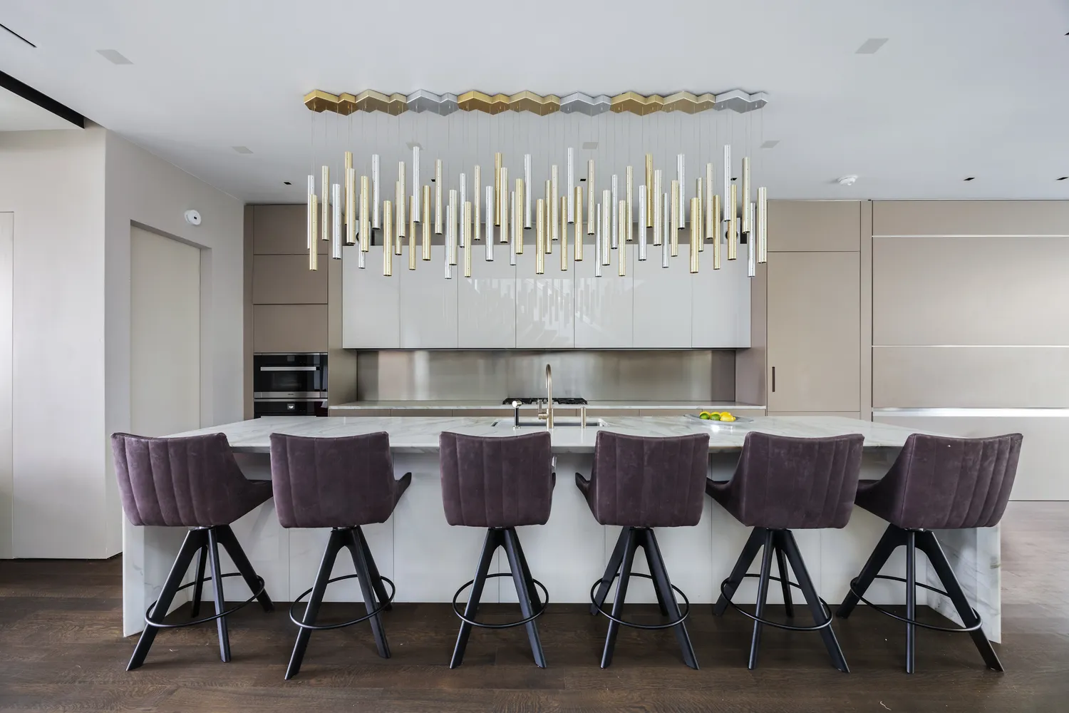 a kitchen with a dining table chairs and wooden floor
