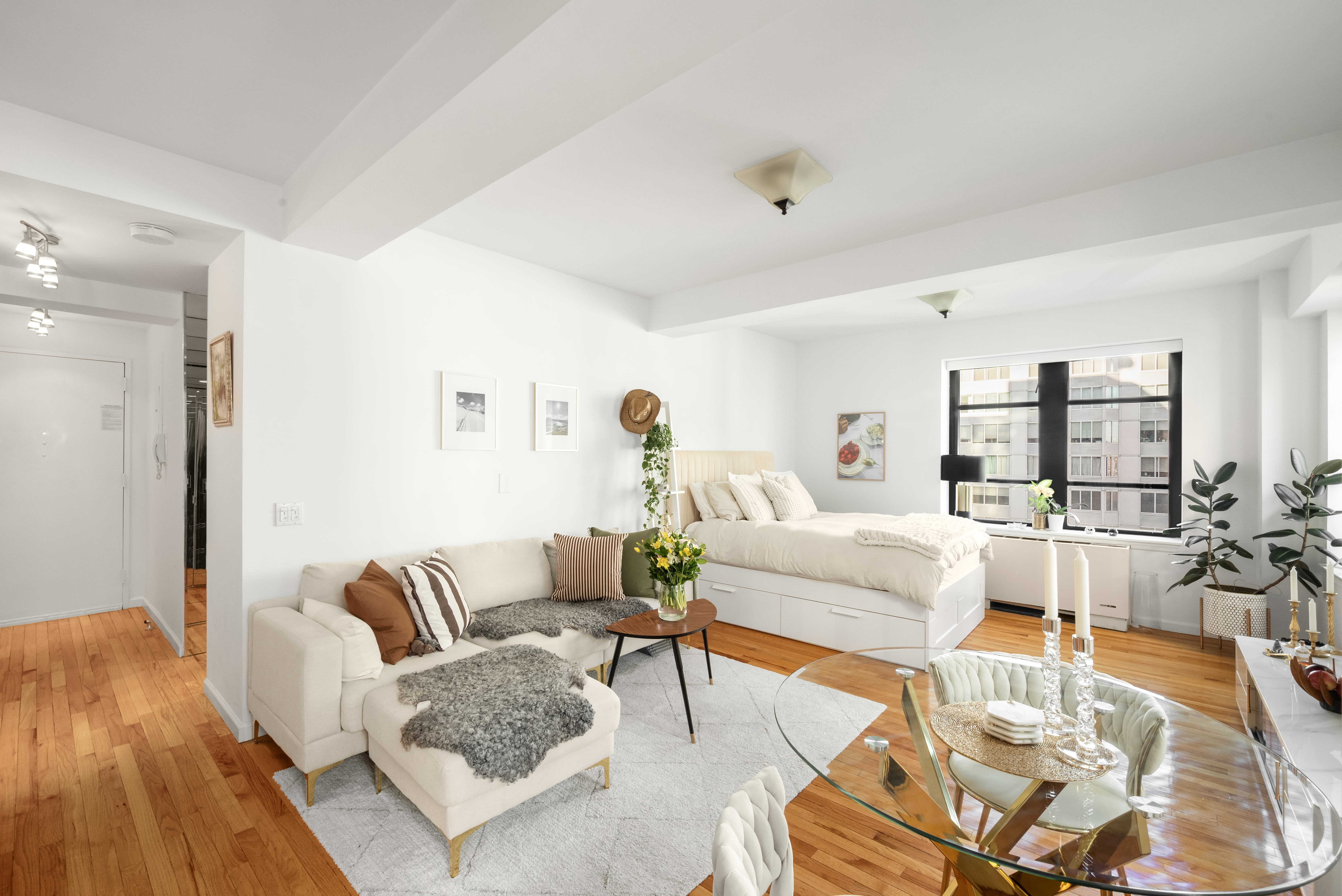 43 West 61st Street, Unit 24Y Manhattan, NY 10023 - Photo 2 of 6 a living room with furniture and a table