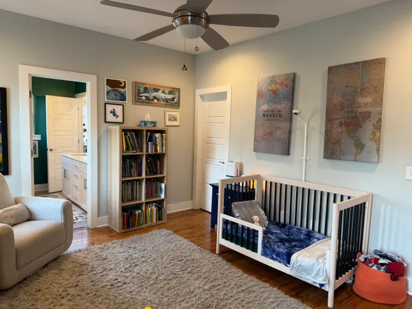 a bedroom with furniture and a book shelf