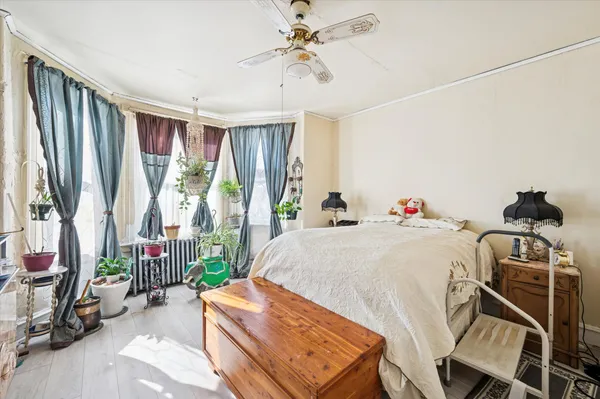 a bed sitting in a bedroom next to a window