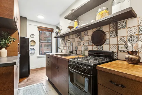 a kitchen with stainless steel appliances granite countertop a stove and a sink