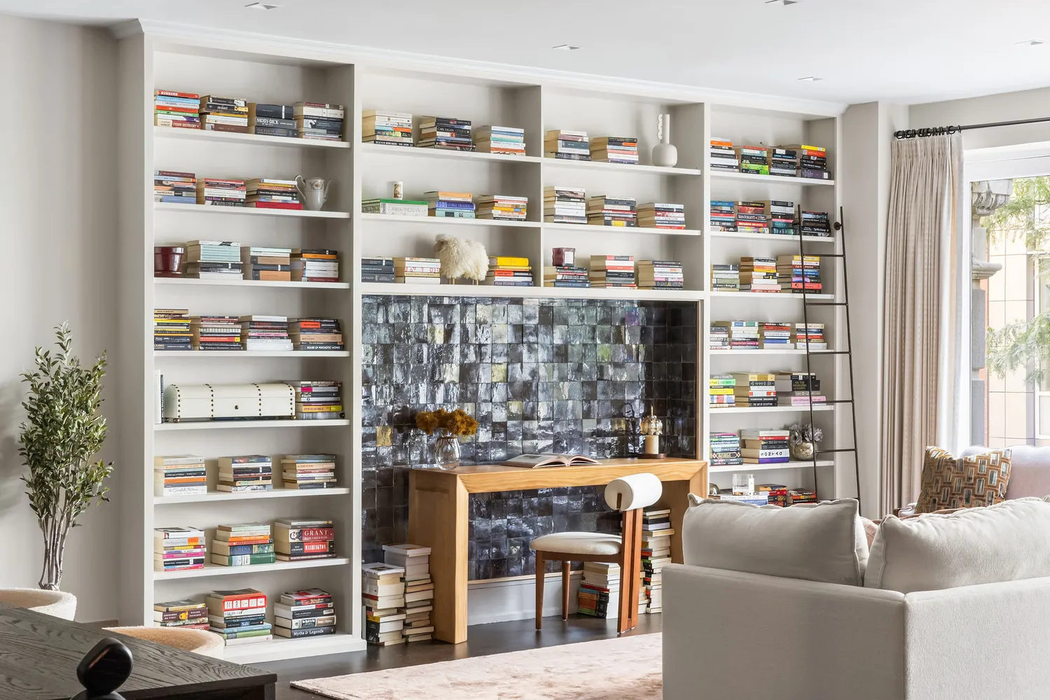 a living room with furniture cabinets and a book shelf