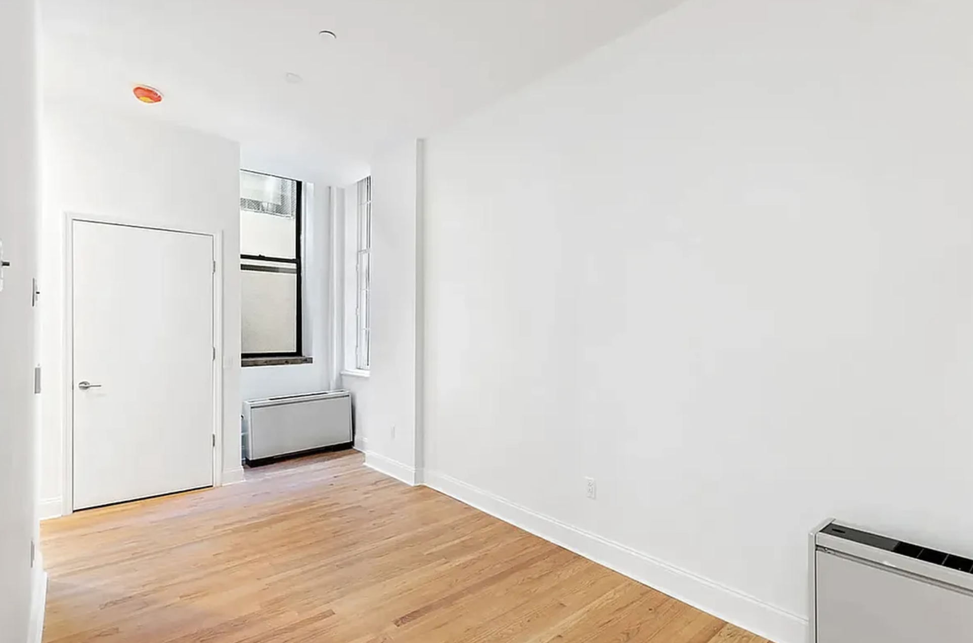 281 Grand Street, Unit 2R Manhattan, NY 10002 - Photo 1 of 5 a view of empty room with closet and window