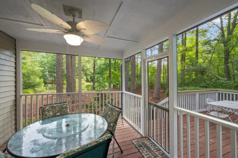 a view of a balcony and dining room