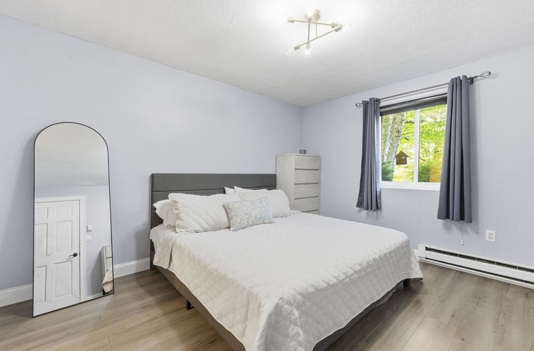 61 Wright Street, Unit 102 Stoneham, MA 02180 - Photo 15 of 26 a bedroom with a bed and a window