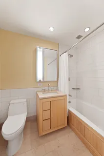 a bathroom with a sink a toilet and bathtub