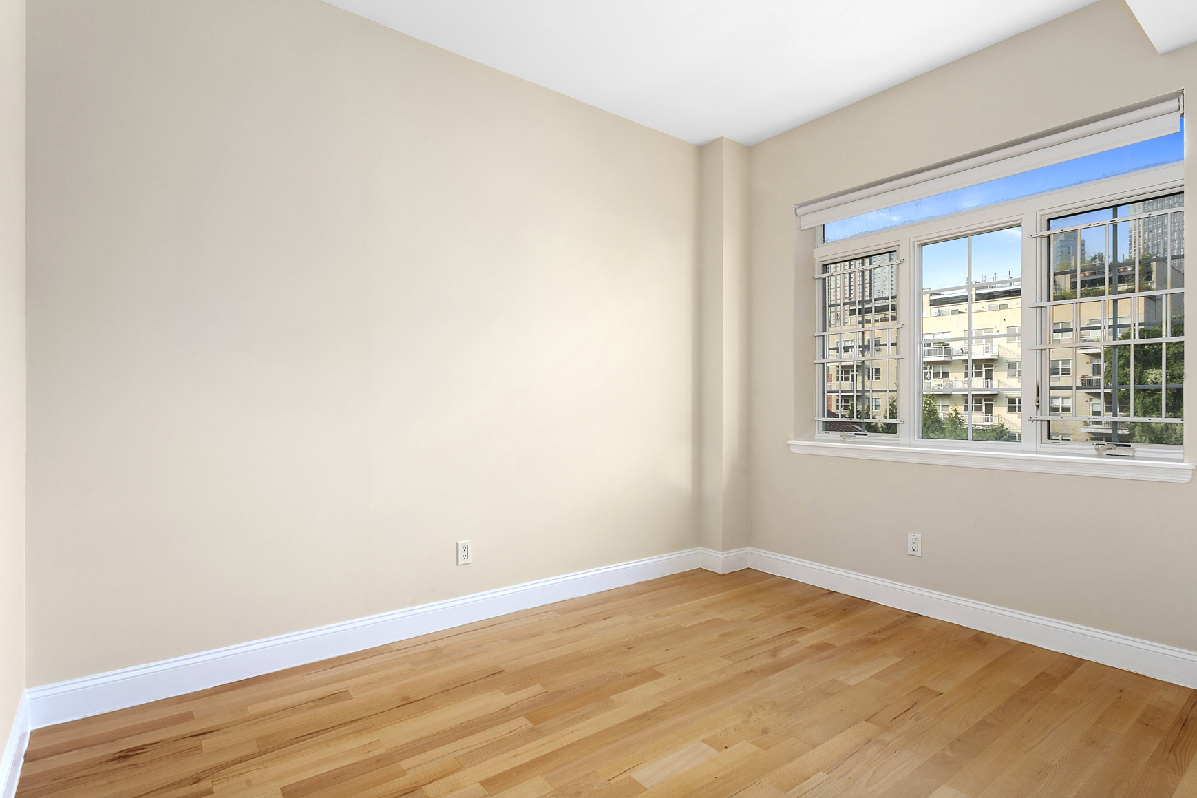 330 Bergen Street, Unit 4D Brooklyn, NY 11217 - Photo 3 of 9 a view of empty room with wooden floor and fan