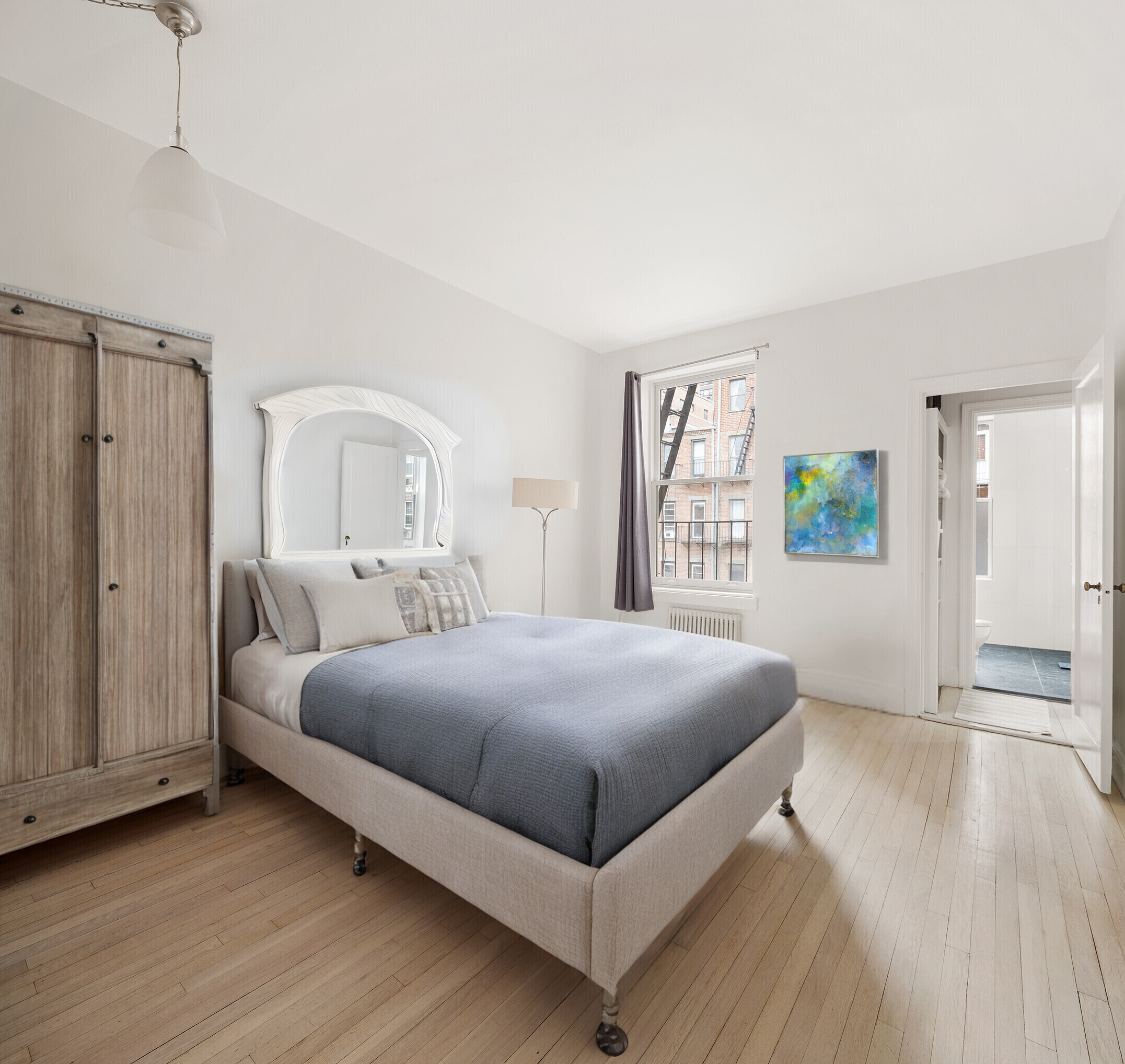525 East 84th Street, Unit 3B Manhattan, NY 10028 - Photo 4 of 10 a bedroom with a large bed and a window