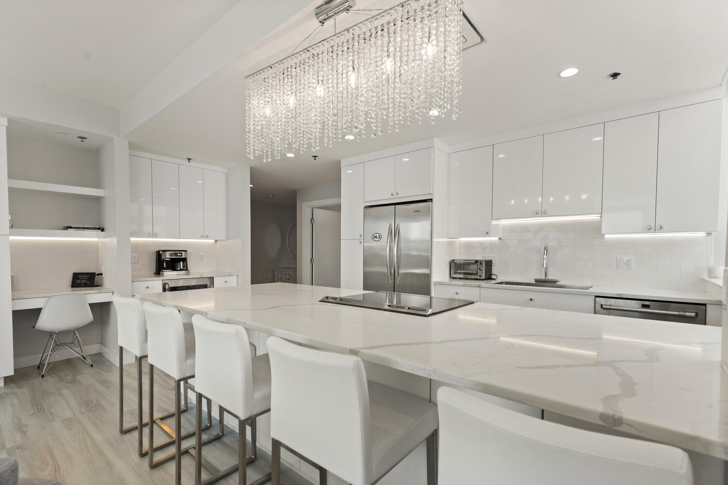 234 Causeway Street, Unit 709 Boston, MA 02114 - Photo 6 of 28 a kitchen with stainless steel appliances kitchen island granite countertop a table chairs and a refrigerator