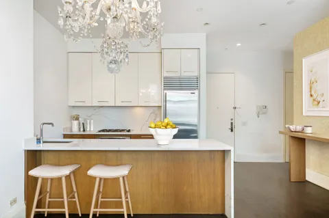 a kitchen with a sink cabinets and window
