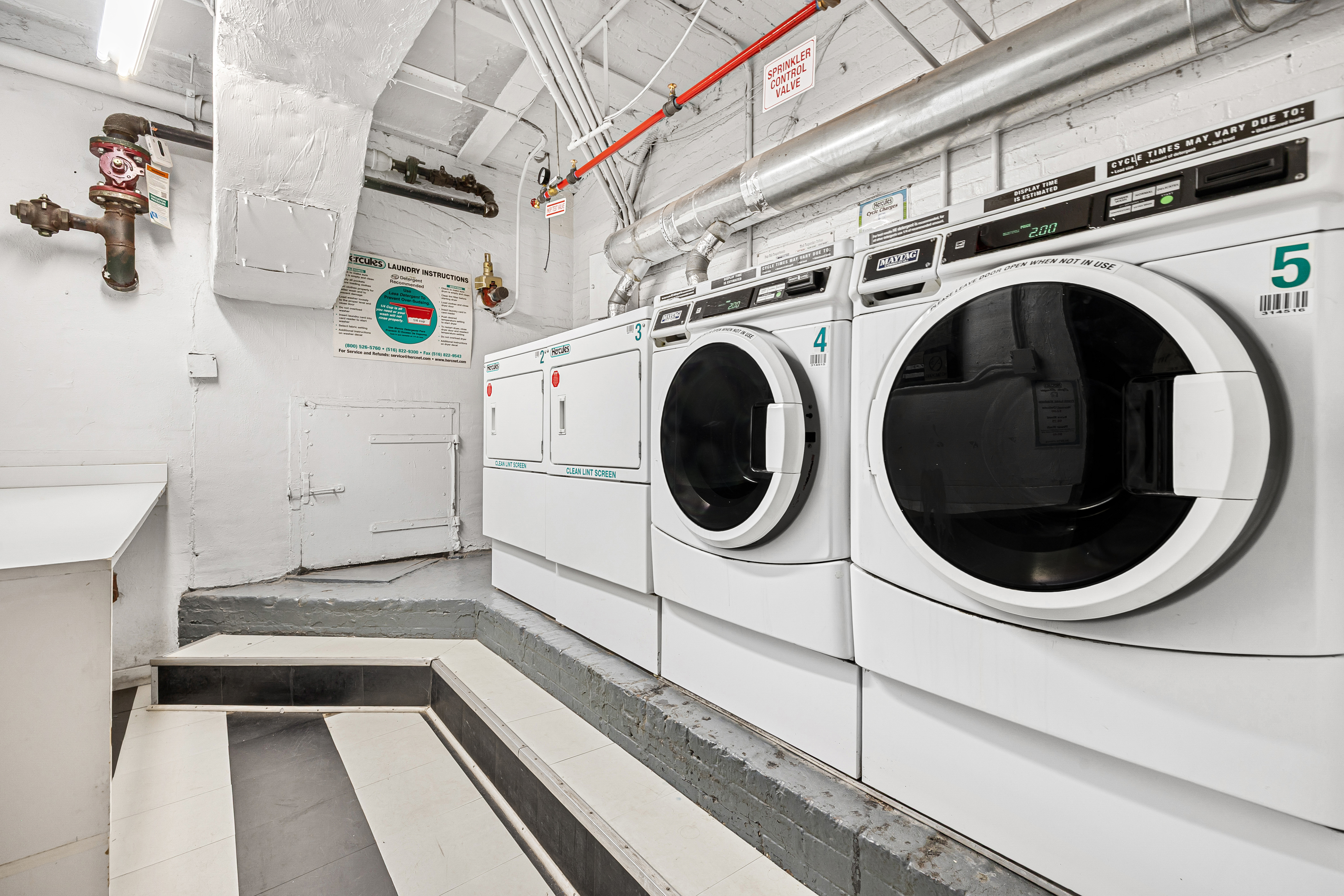 284 5th Avenue, Unit 6C Manhattan, NY 10001 - Photo 8 of 9 a utility room with dryer and washer