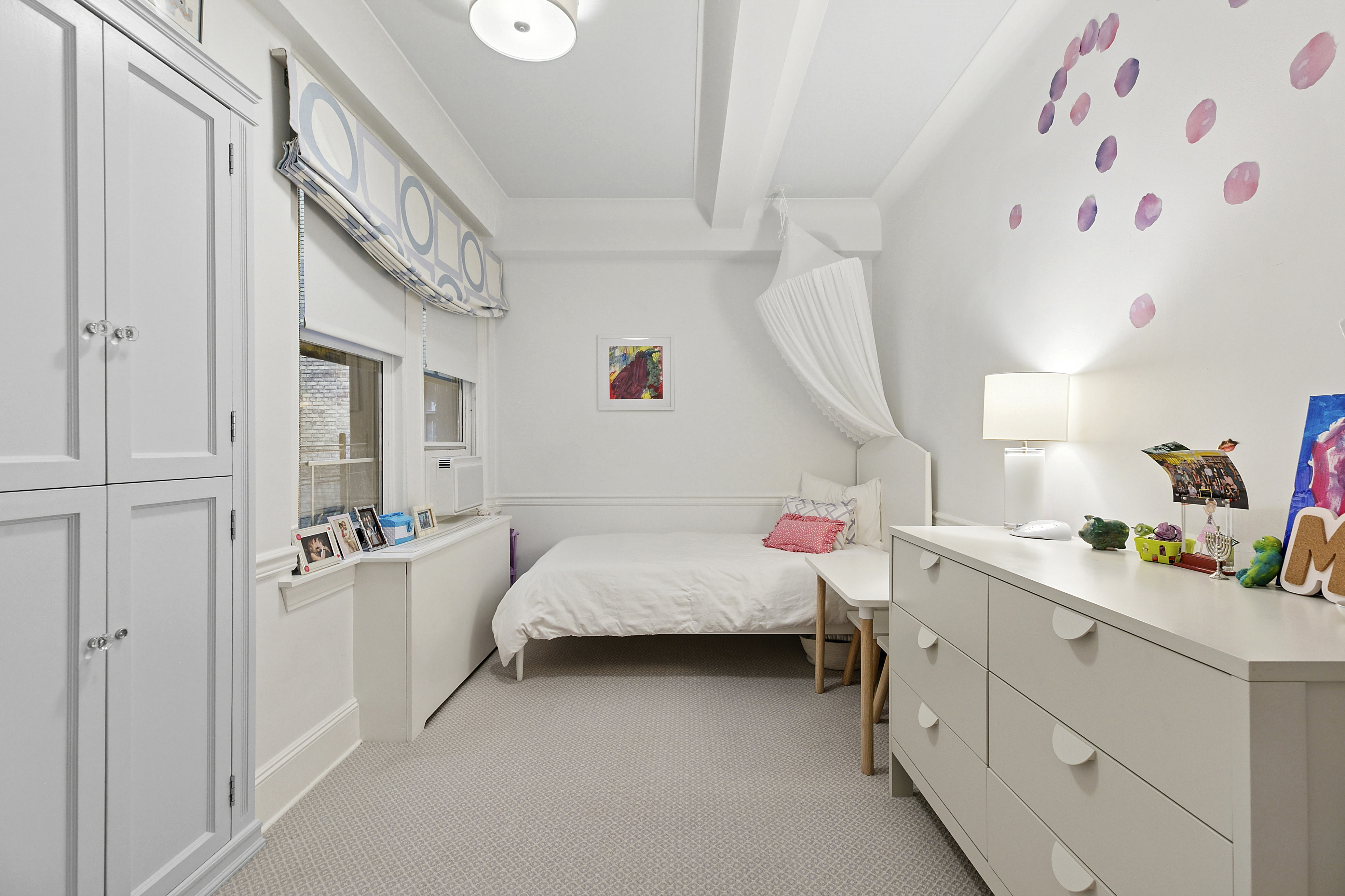 205 East 69th Street, Unit 3A Manhattan, NY 10021 - Photo 7 of 11 a bed room with a bed and a window