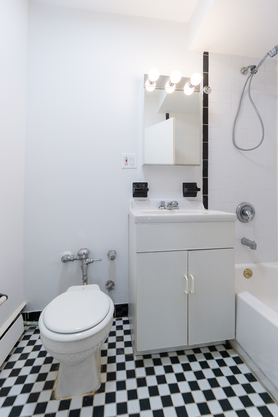 227 East 5th Street, Unit BE Manhattan, NY 10003 - Photo 4 of 7 a bathroom with a sink a toilet and a mirror