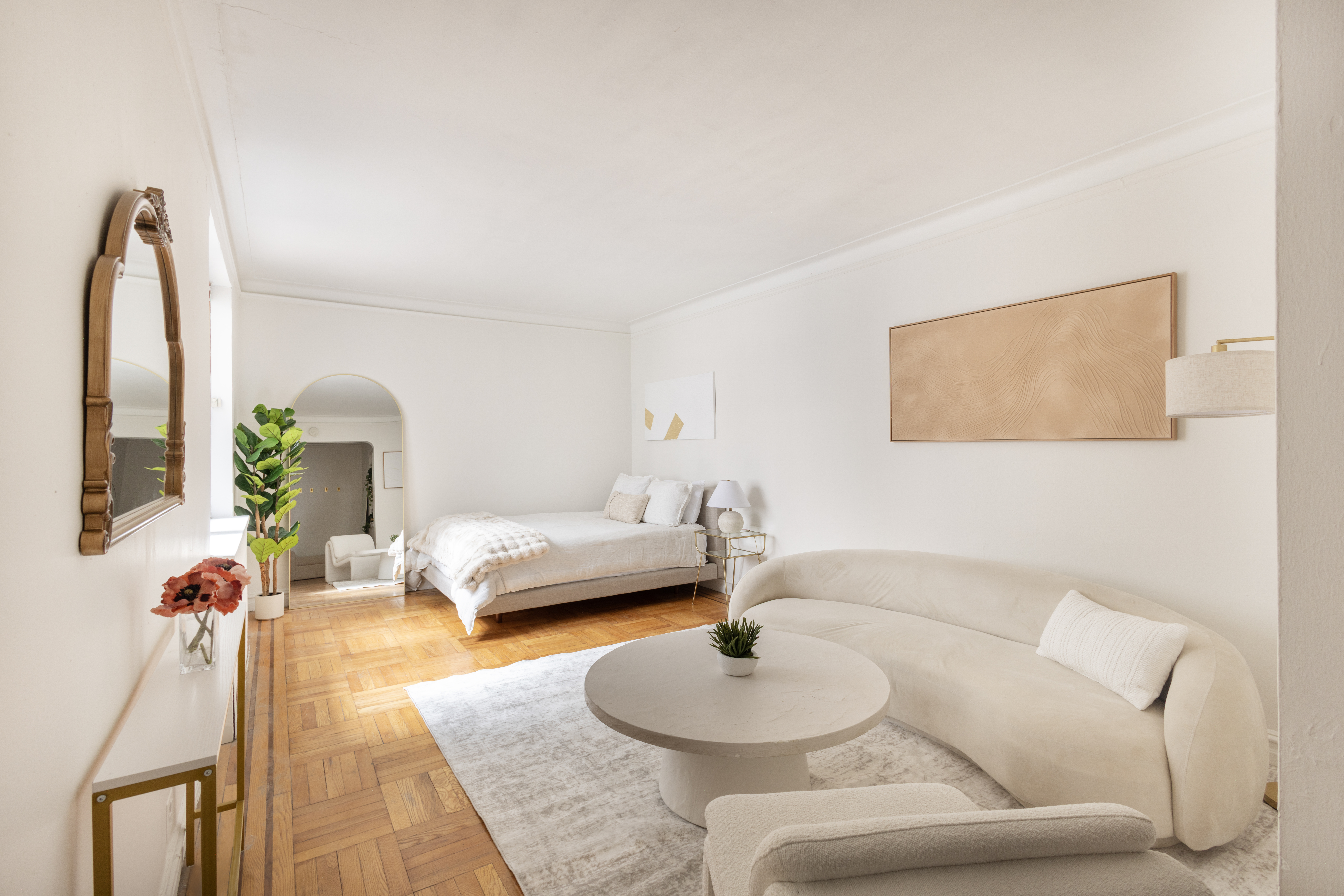 a living room with furniture and a wooden floor